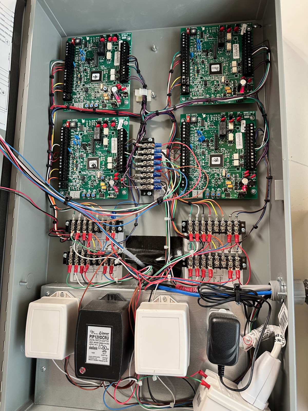Interior of a DoorKing four-door controller panel showing wiring and terminal blocks