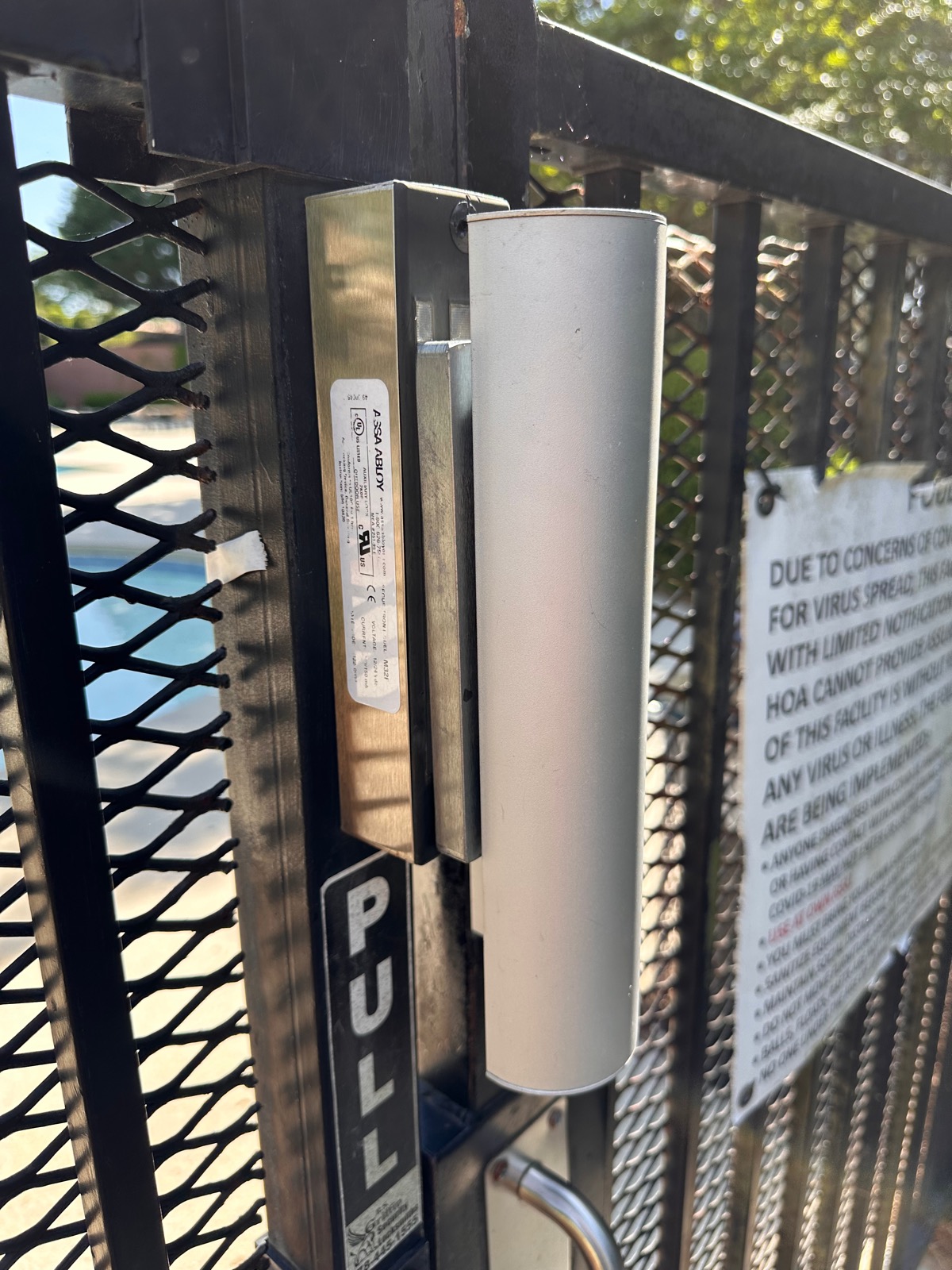 Magnetic lock and card reader installed on a community pool gate