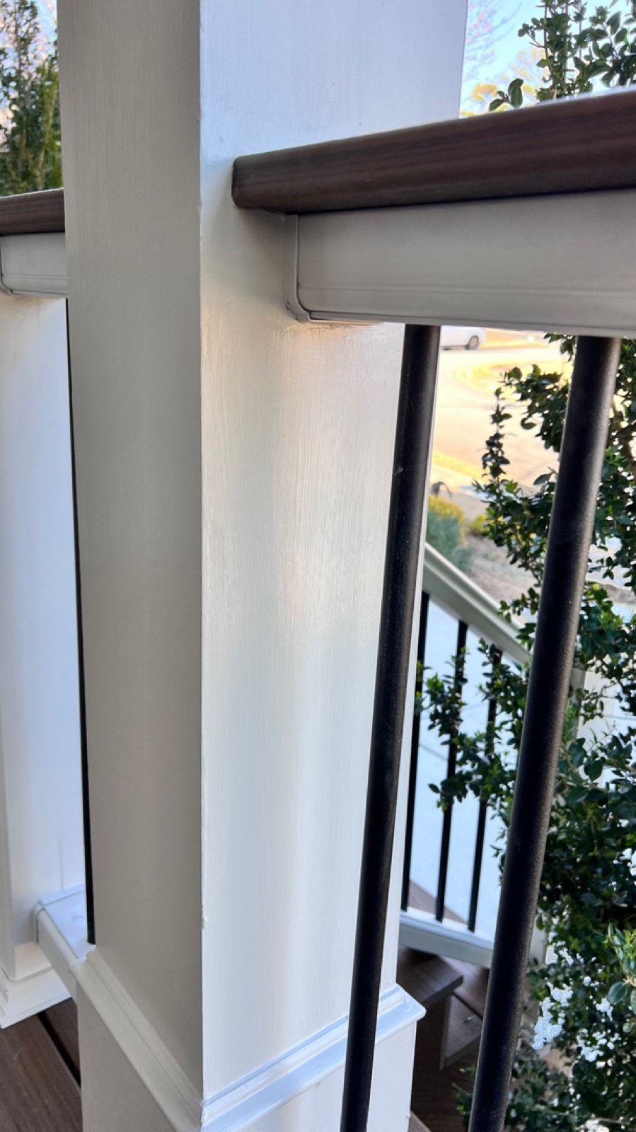 Detail: Havana Gold top rail, freshly painted posts, and black aluminum balusters