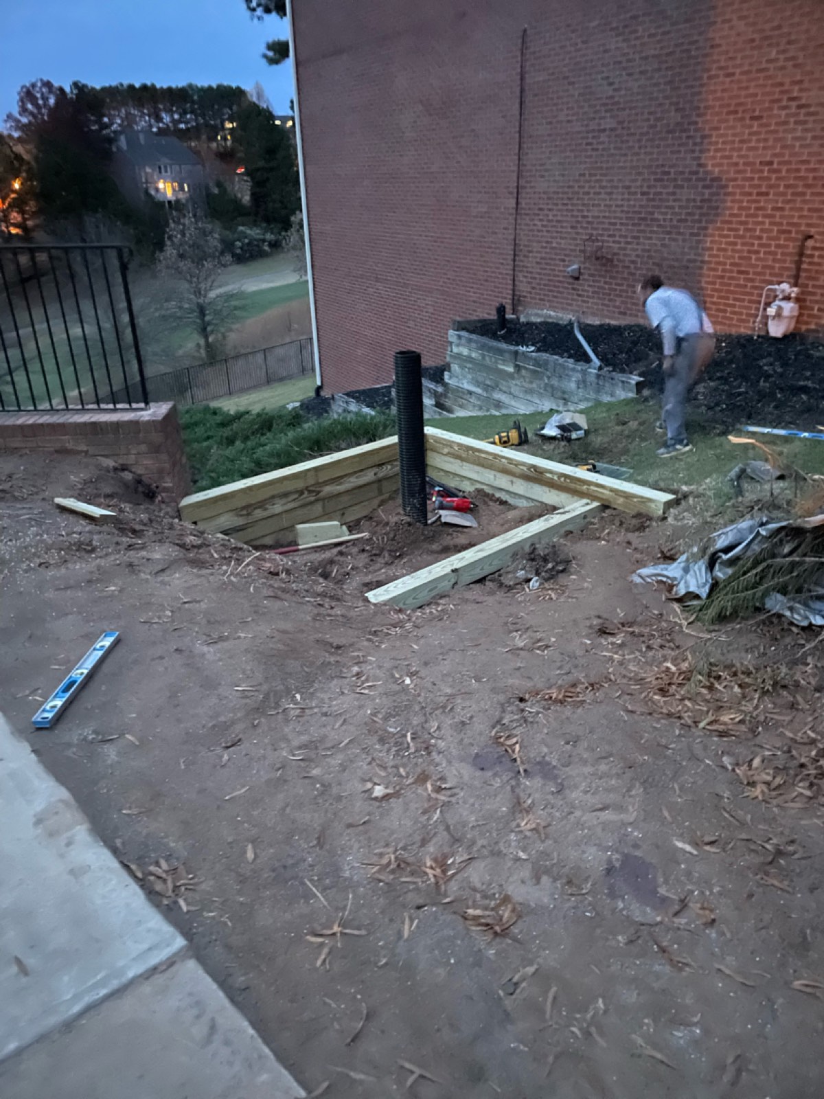 New retaining wall, drain head, and smooth-wall drainage pipe going in on the hillside