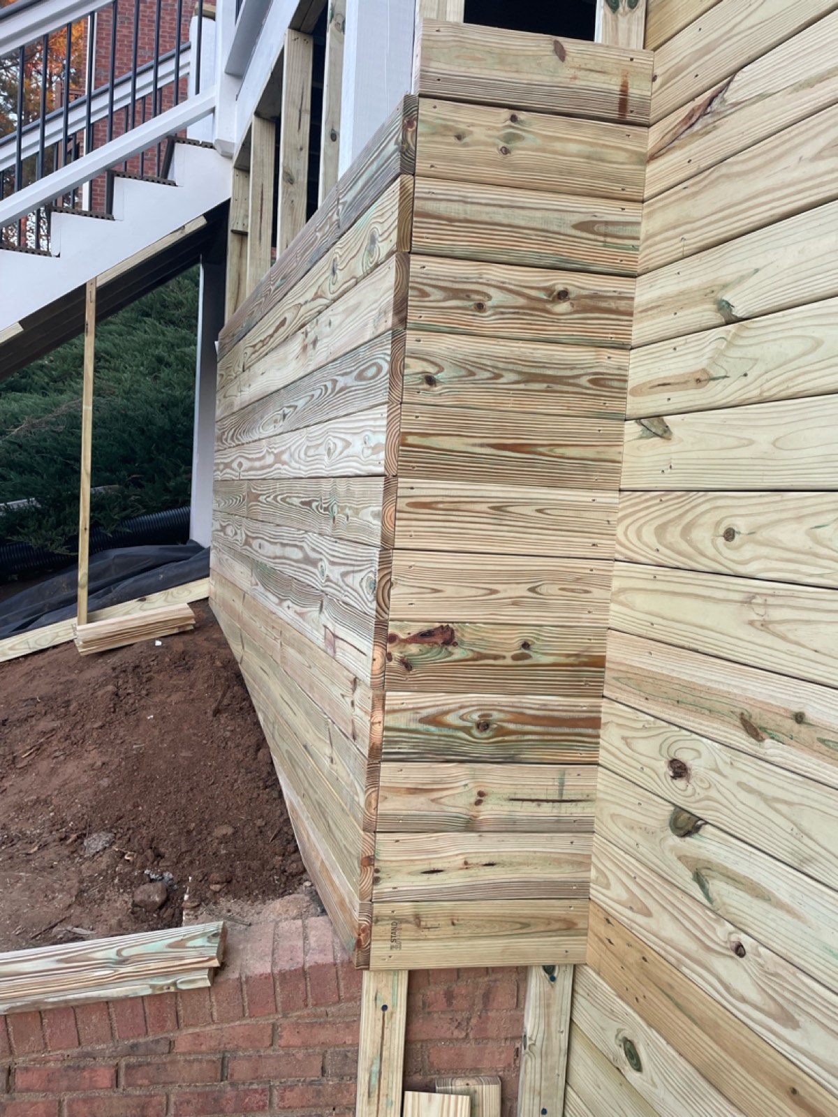 Pressure-treated slat wall built to conceal the underside of the raised deck